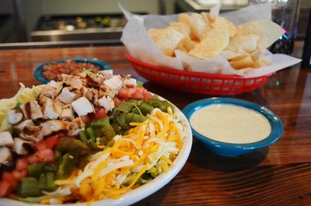 chuys florence ky creamy jalapeno dip, chips, plate of mexican food showcased on a bar