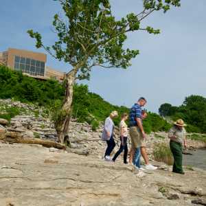 Family walking with the park ranger at Falls of the Ohio