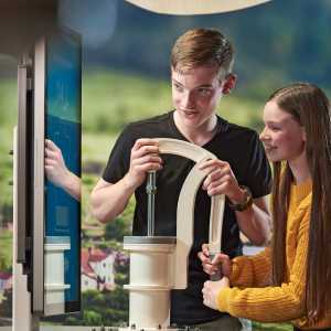 [ID: a photo of two people at Science World during the Earth Matters: Rethink the Future exhibition.]