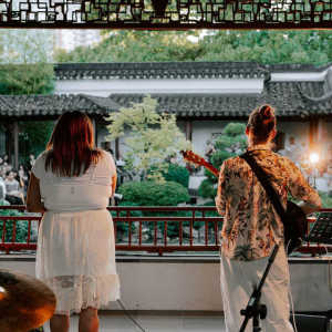 [ID: a photo of two performers during the Enchanted Evenings Concert Series - Filipino Heritage Month.]