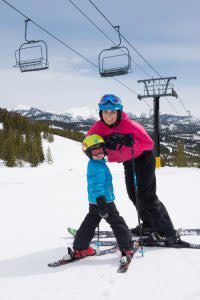 Mother teaching her child how to ski at Moonlight Basin in Big Sky