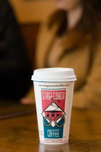 A coffee cup on a counter that says Stagecoach Coffee