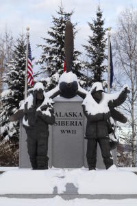 a statue of two servicemen standing in front of a large airplane propeller - memorial to US and Russia cooperation in World War II