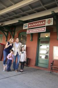 A family standing outside of a train station