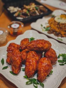 White plate with sauce-covered chicken wings
