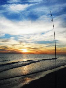 Fishing pole in the sand at sunrise on Boca Grande
