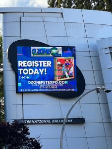 Digital sign at GICC displaying information about the Ozone Pet Expo.