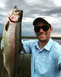 large trout held by man