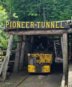 Picture from Pioneer Tunnel Coal Mine. The Coal mine vehicle sits on the tracks with passengers seated and ready to take off and head off deep into the mountain coal mine.