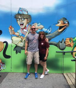 couple in front of mural