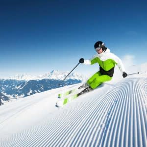 dynamic skiing on groomed run | Shutterstock
