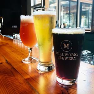 Dark and light beers poured in glasses from The Millworks
