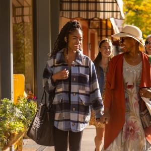 Window Shopping in Front of Maria's Bookstore During Fall