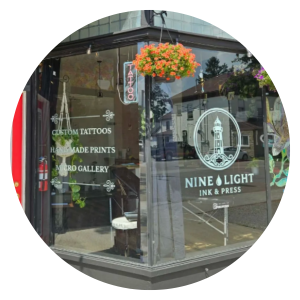 Image of the storefront window of Nine Light Ink and Press