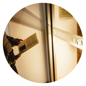 Image of hands holding a brochure inside of a glass door in the art gallery