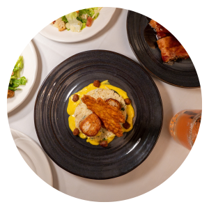 Circular image of dish made by chef at The Elm Hurst Restaurant