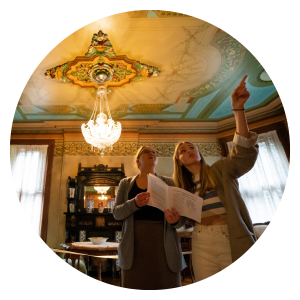 Circular image of people looking at the interior of the Annandale National Historic Site