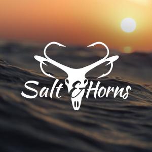 White logo on a sunset water background. The logo says "Salt & Horns" and has an outline drawing of a deer. The antlers on the deer are fish hooks.