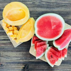 yellow and red watermelon cut open and sliced