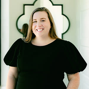 Woman dressed in black and smiling