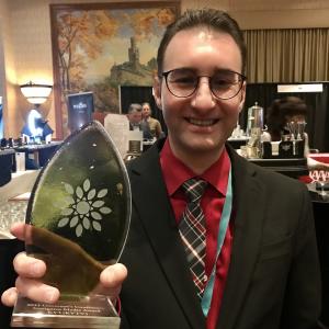 Spencer Ernst of KYTV holding award.