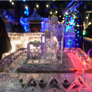Candles and table carved out of ice at Funky Ice Fest