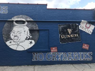 The "No crybabies" mural on the side of Five Points Bottle Shop.