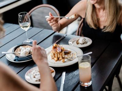 Two women eating dessert at Little West Tavern