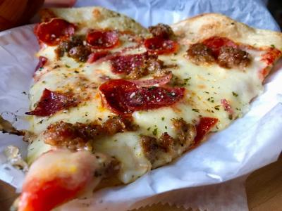 Slice of sausage and pepperoni pizza from Mikey's Late Night Slice