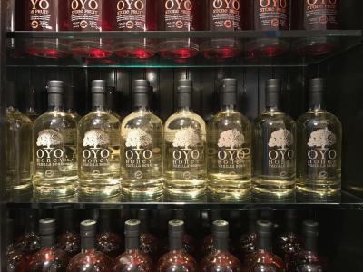 Shelf fully-stocked with a variety of OYO liquor bottles