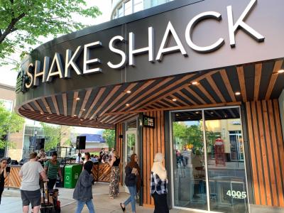 View of storefront and customers walking into front doors of Shake Shack Easton