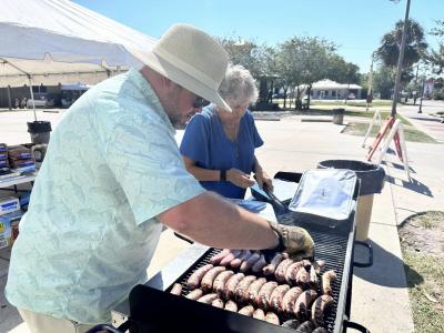 Men grilling brats at the PortOberfest