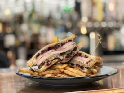 Plated sandwich with fries at Bluegills Bar & Grill