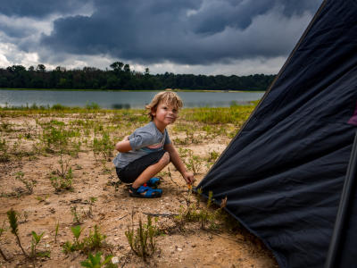 A little boy camping at the lake at Howell Woods, Four Oaks, NC.