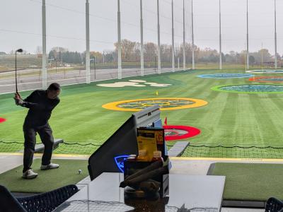 Player swinging a club at Topgolf Woodbury