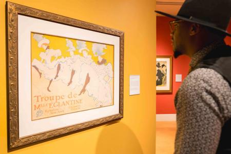 Man looking at Toulouse Lautrec portrait