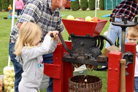 Operate an apple cider press at the Fall Colors Festival. (Photo by Deb Stukenborg)