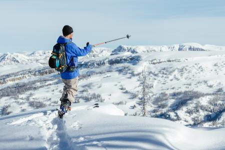 Backcountry skier looking over tetons