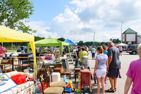 Shoppers stroll multiple vendor booths at a location along the 301 Endless Yard Sale