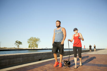 walking along harbor in HarborPark with dog