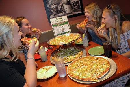 Ladies eating pizza at Kaiser's