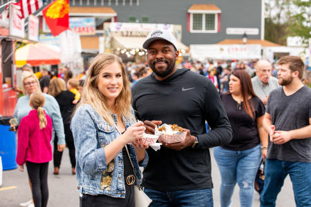 Couple stands with food at Fort Ligonier Days