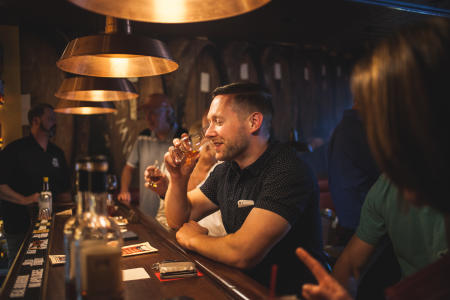 man drinking bourbon at prohibition bourbon bar in newport ky