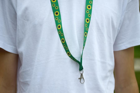 person with a white shirt wearing a sunflower lanyard