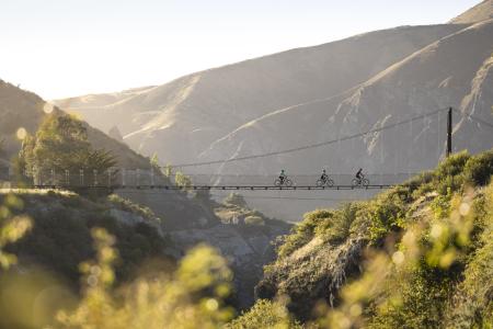 Three people biking on Edgar Bridge, Gibbston Valley Trail