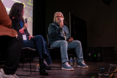 Director Brit McAdams on panel on stage