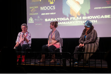 people sitting on stage for dance panel at film showcase