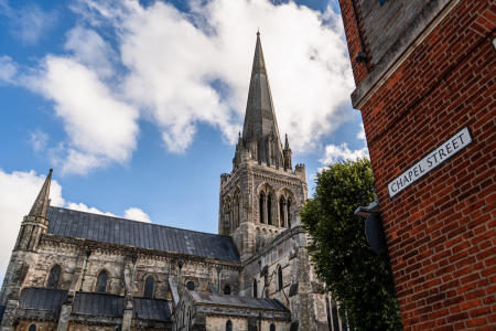 Exterior view of Chichester Cathedral from Chapel Street looking at the spire