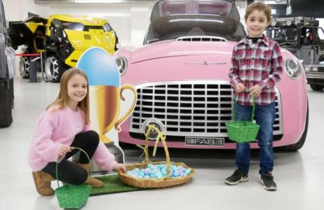 Children with Easter hunt baskets in front of a pink Rolls Royce