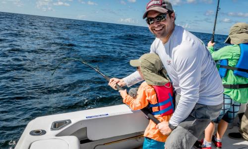 Man and Child Fishing Off A Boat In Corpus Christi, TX